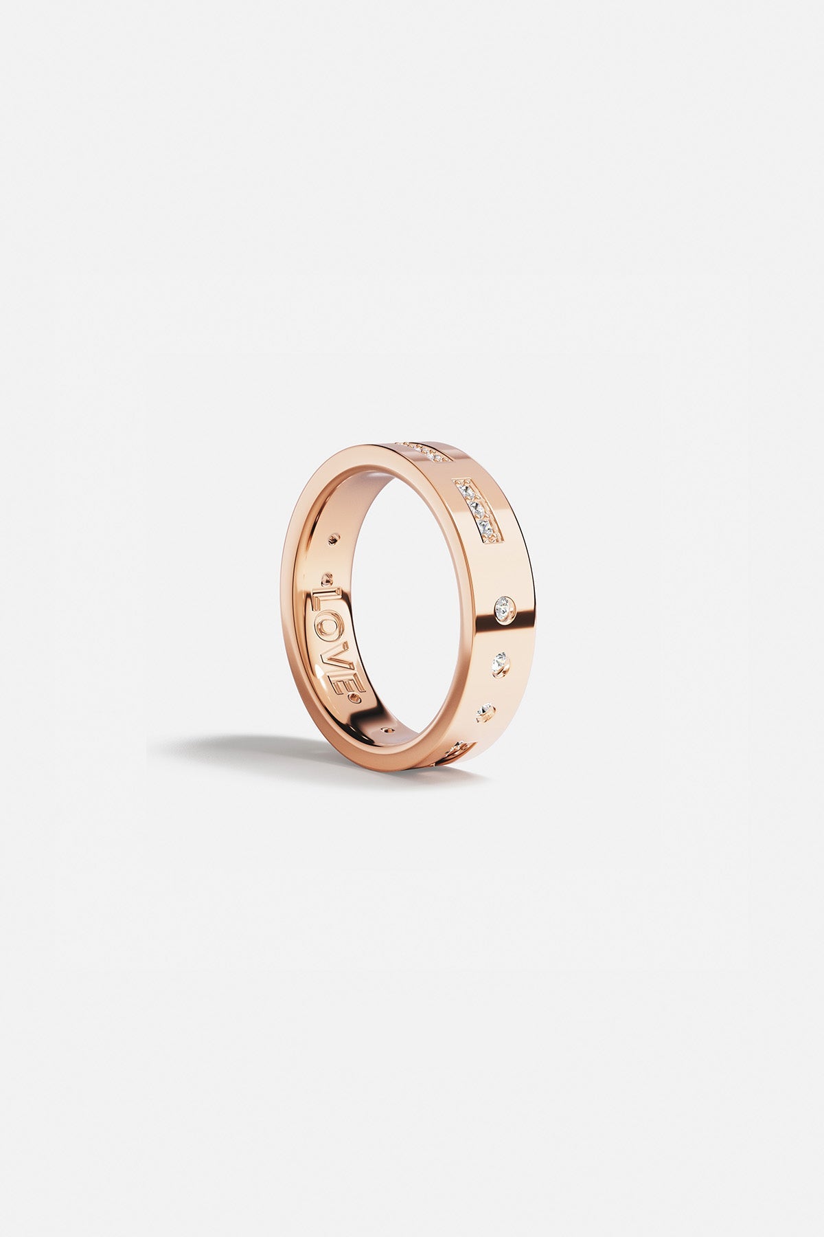 Rings APM Monaco. Rose gold ring featuring a LOVE Morse-code design with small diamonds and star accents.