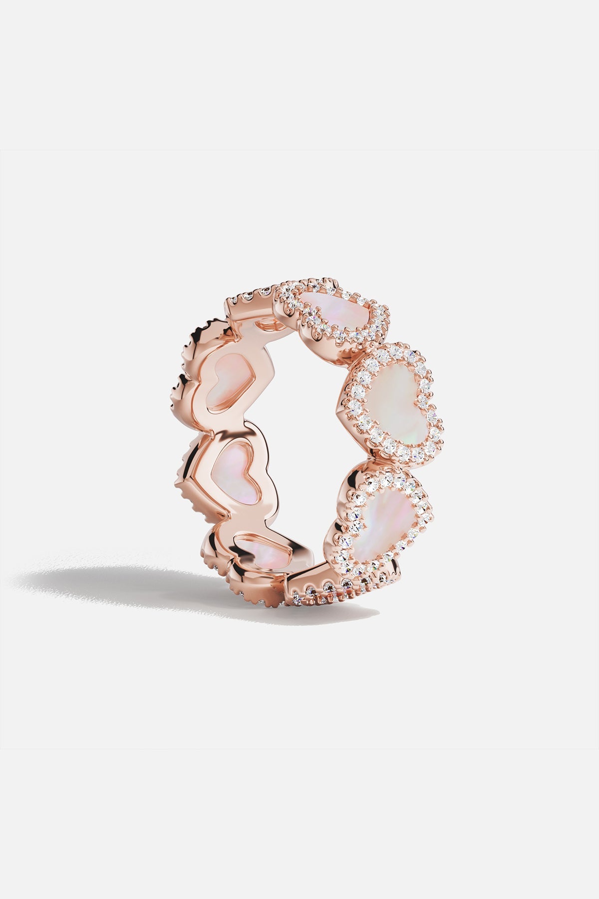 Rings APM Monaco: rose gold pavé ring with pink nacre hearts encircling the band, set with pavé diamonds.
