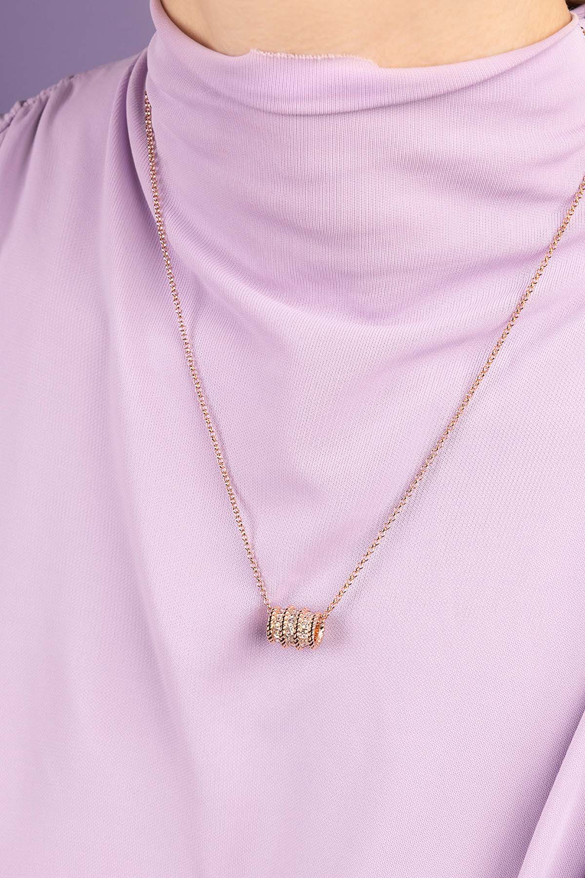 APM MONACO Torsade Adjustable necklace in rose gold worn on model with purple T-shirt