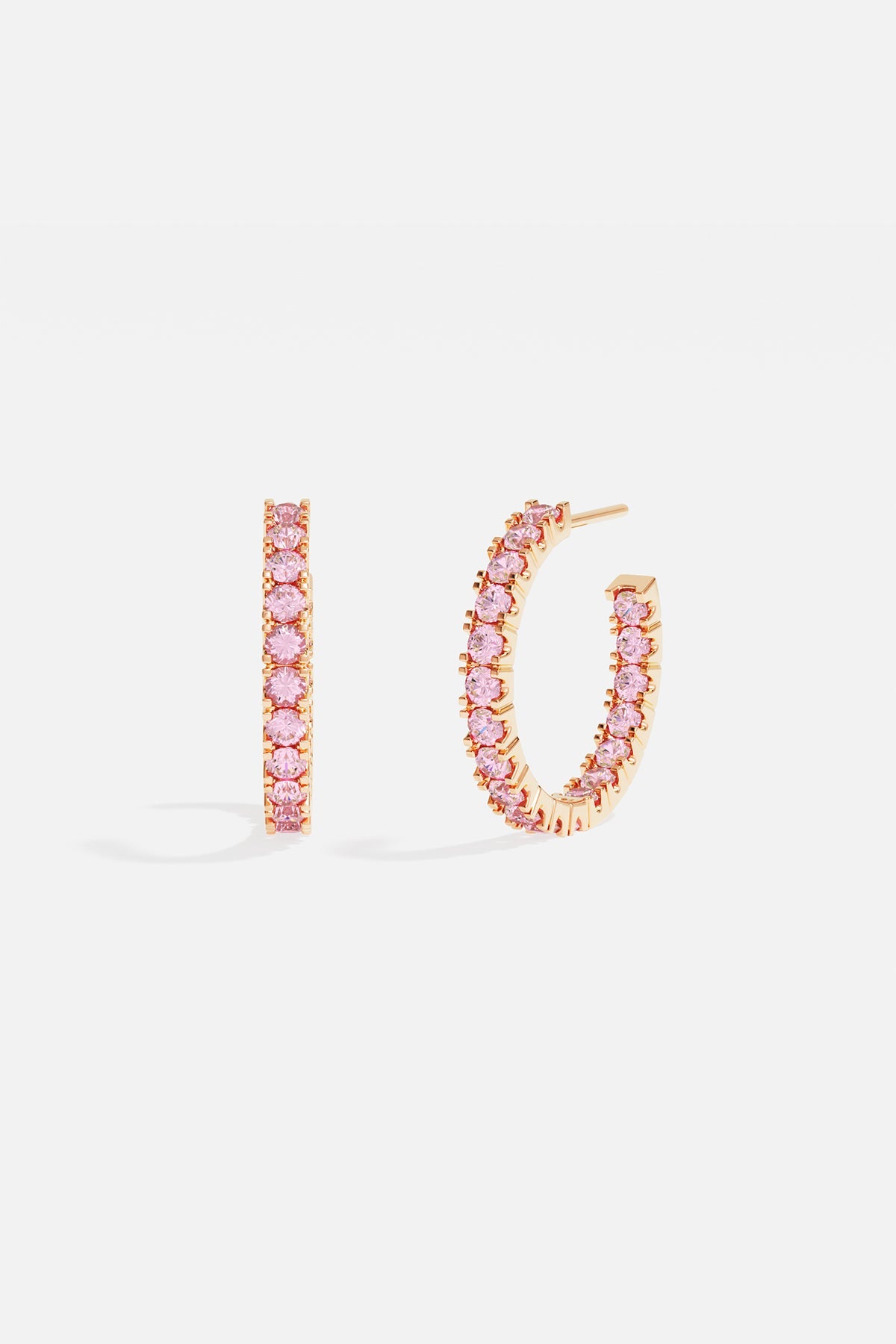 Earrings APM Monaco, yellow gold-tone pavé hoop earrings with pink stones.