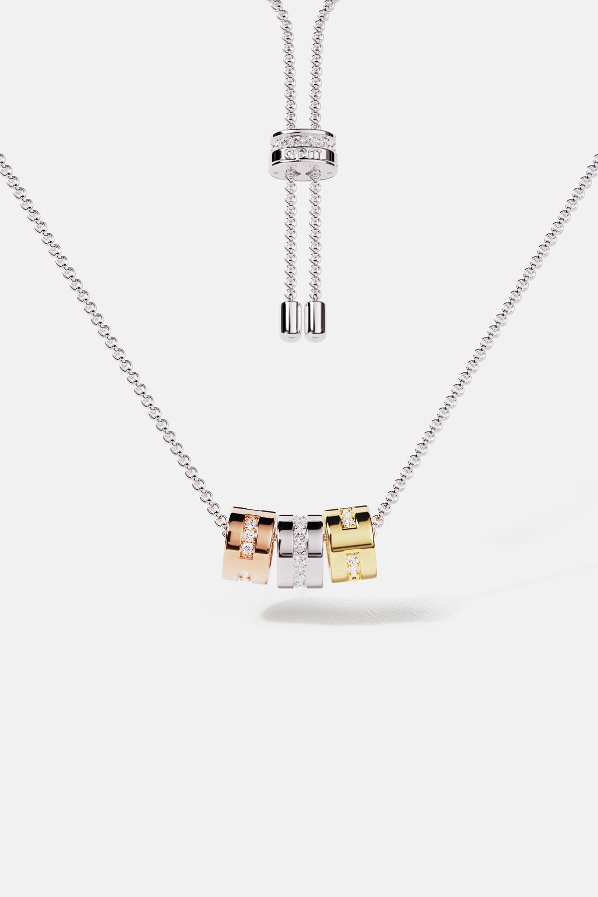 Necklaces APM Monaco adjustable morse-code necklace with three square rhinestone pendants in gold, silver, and pink tones.