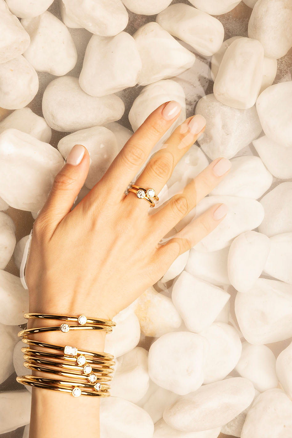 Rings APM Monaco. Yellow Gold stacked rings on a woman's hand.