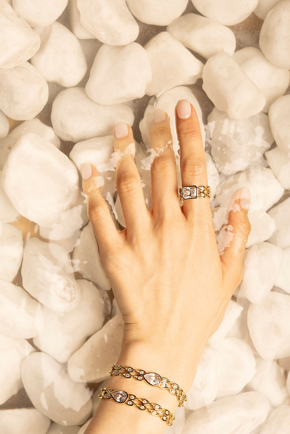 Rings, APM Monaco. Yellow gold statement ring with white diamonds; matching chain bracelet in yellow gold.