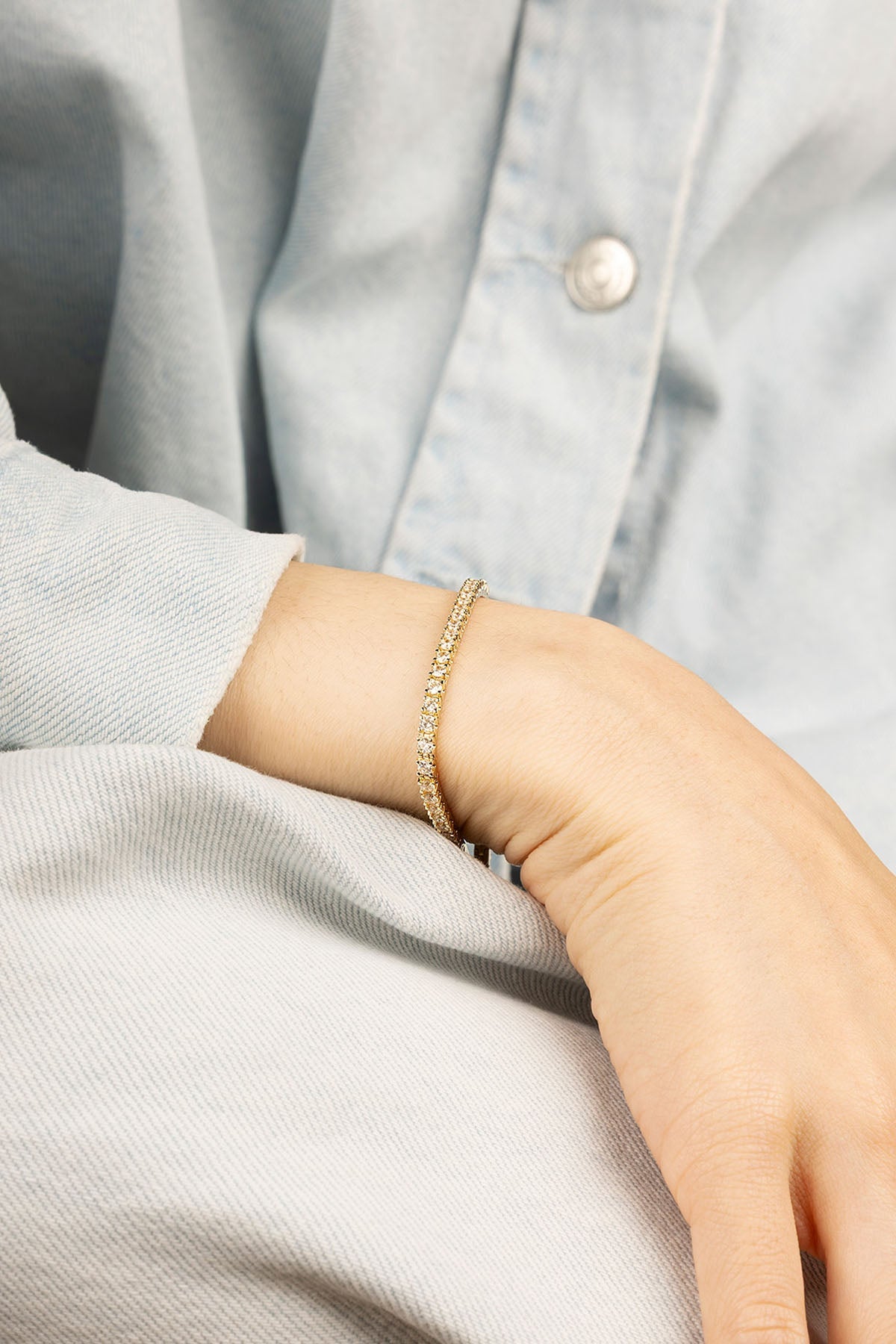 Bracelets APM Monaco, yellow gold tennis bracelet with white diamonds.