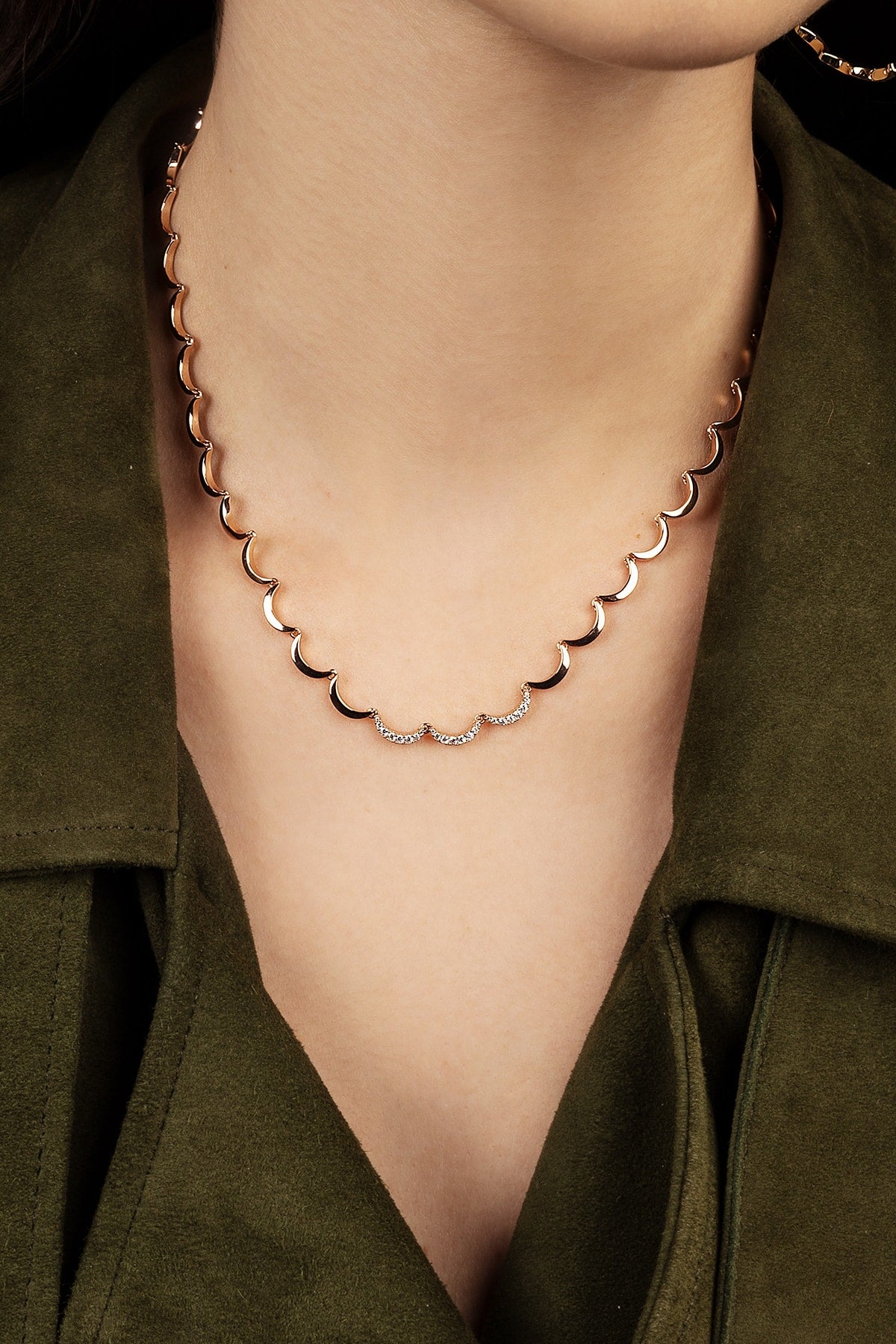 Necklace with a green jacket worn by a model