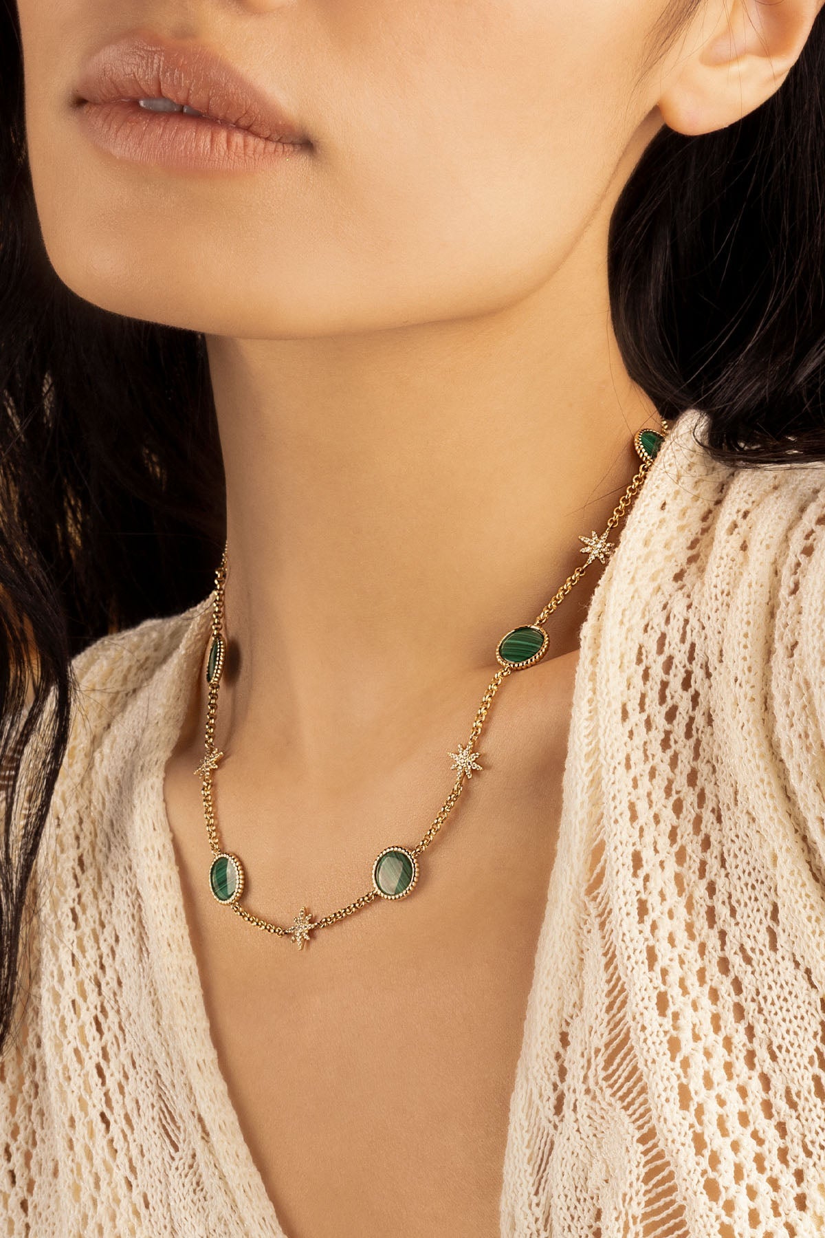 Necklaces APM Monaco, yellow gold choker with malachite stones and small starburst accents.