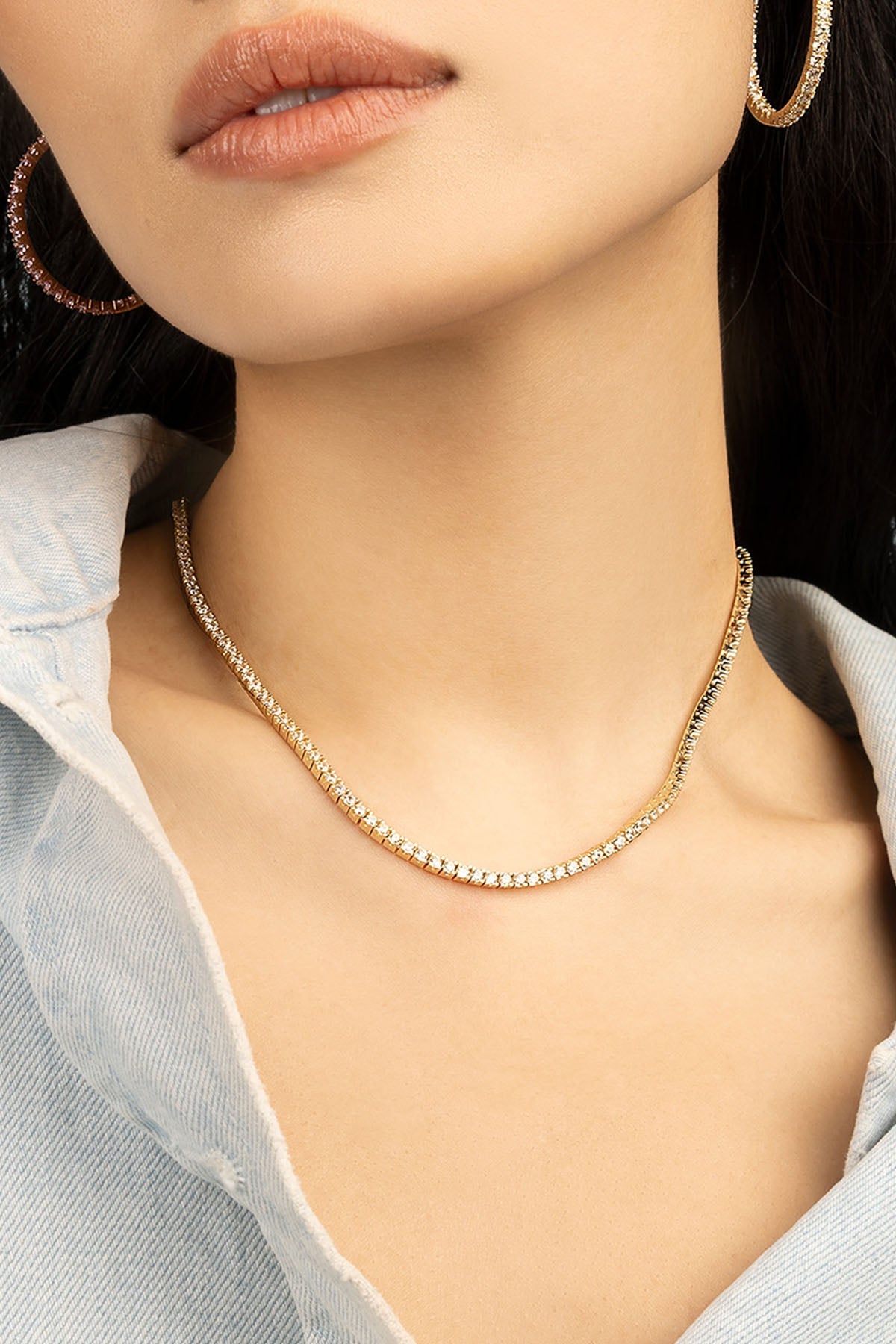 Necklaces APM Monaco: pavé choker in yellow gold; Earrings APM Monaco: large yellow gold hoops.