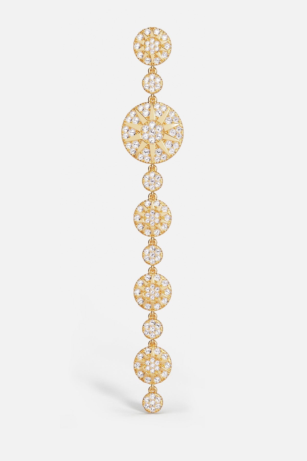 Earrings, APM Monaco: long soleil drop earrings in yellow gold-tone with pavé diamonds and sunray design.