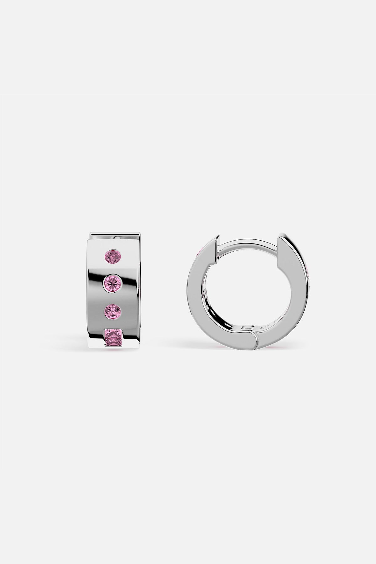 Pair of silver hoop earrings with pink gemstones on a white background